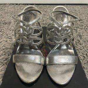 Carlos Santana, necktie-silver strappy heels.